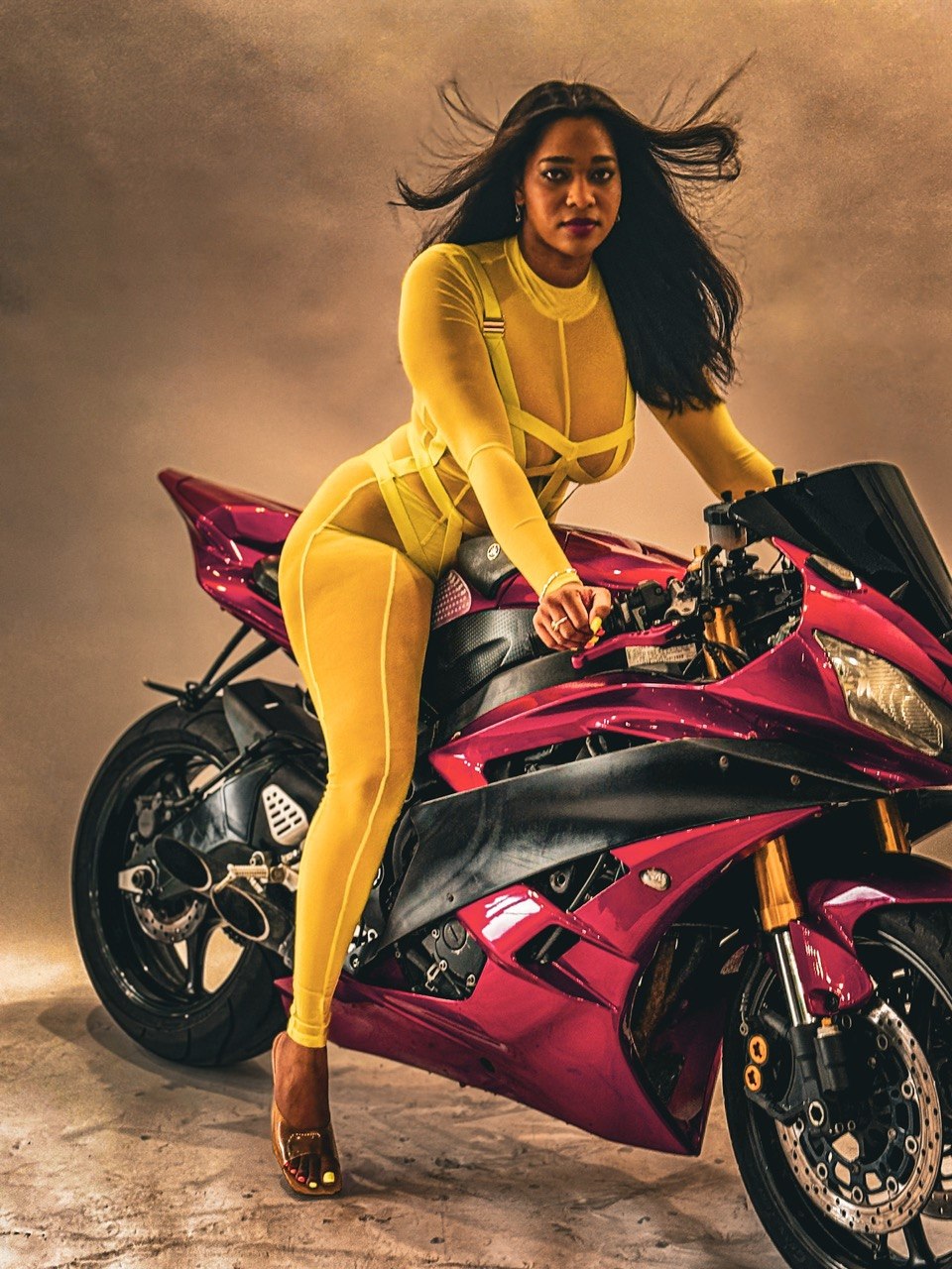 Woman in Yellow on Red Motorcycle